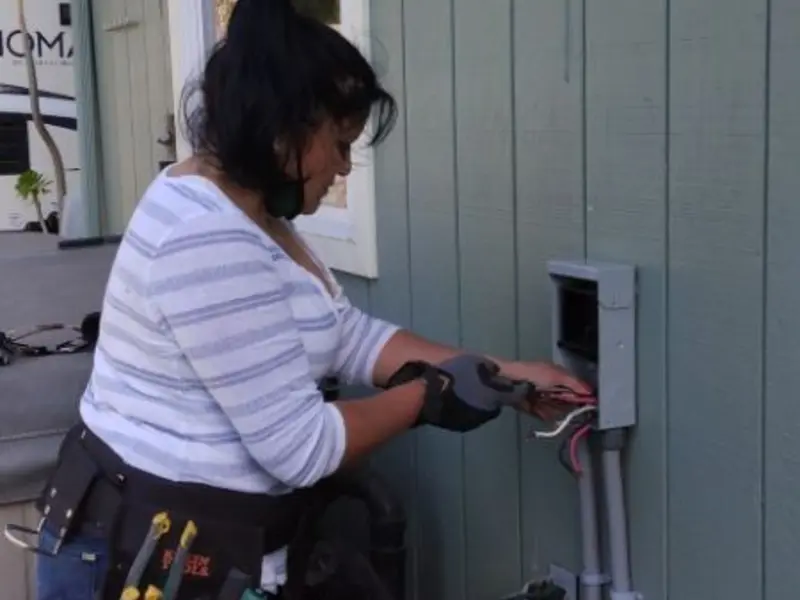 Licensed electrician wiring an exterior subpanel in Pendleton